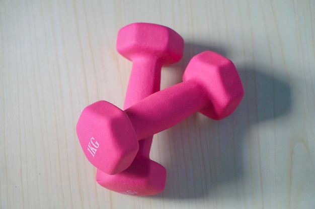 Two pink 1kg dumbbells Weights for a fitness training