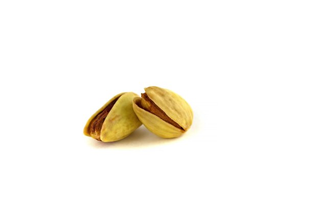 Two pistachio nuts isolated on a white background