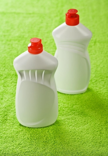 Two plastic bottles on green towel