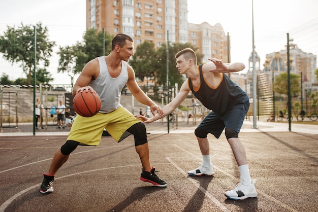 Premium Photo  Two players in the center of the basketball field on  outdoor court.