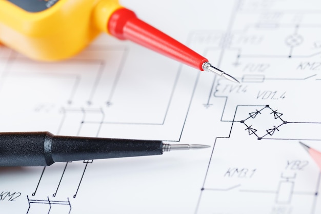 The two-pole voltage indicator lies on the electrical drawing. Testing and verification of power grids