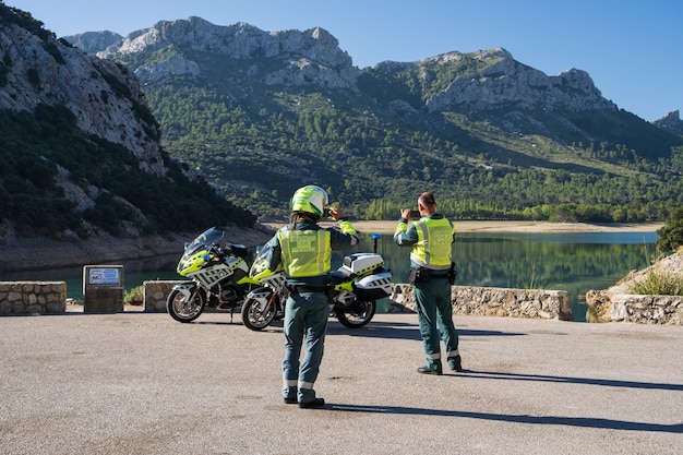 Two policemen on motorcycles near the lake Torrent de Gorg Blau in Mallorca Spain