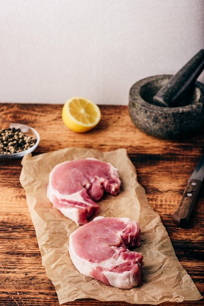 Two pork loin steaks with lemon and peppercorn