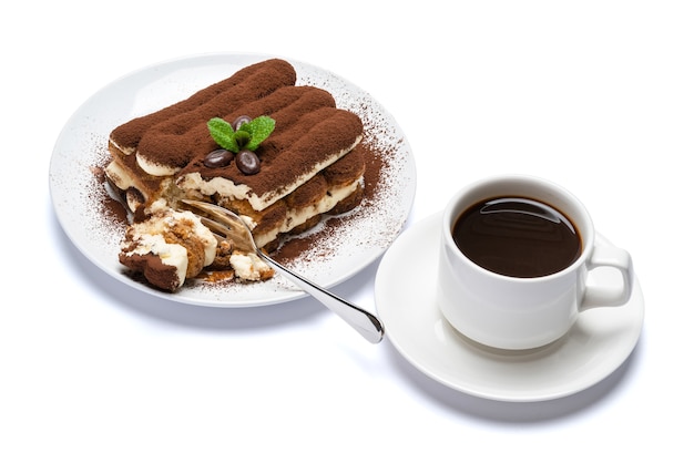 Two portions of Classic tiramisu dessert on ceramic plate on concrete background or table