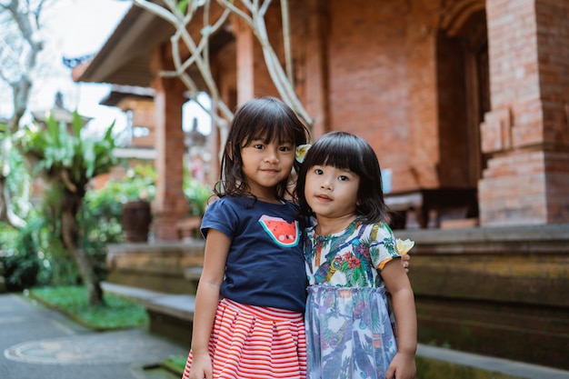 Two pretty girl standing in front of traditional house