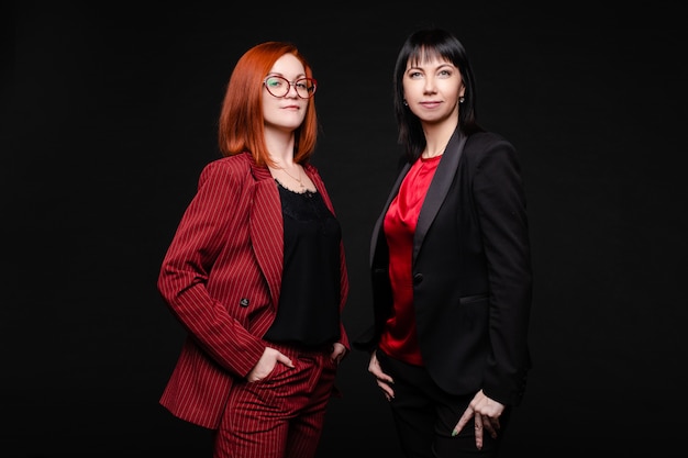 Two pretty women wearing stylish suits 