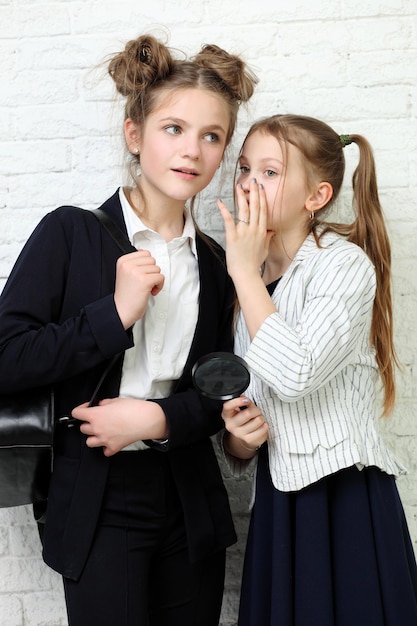 two pretty young school teenage girls having fun happy smiling on white background