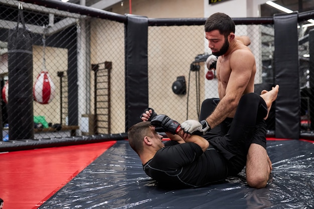 Two professional boxers in dynamic boxing action on the ring at gym. Boxer hit opponent, making various fighting tricks, sport concept