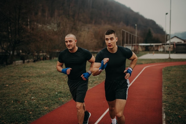 Two professional boxers running outside and preparing themself for training