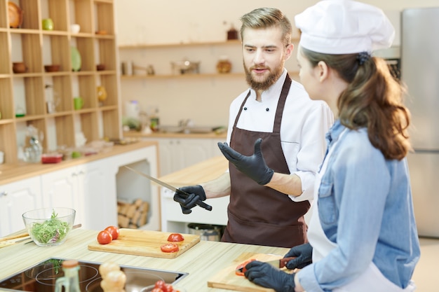 Two Professional Chefs Cooking in Cafe