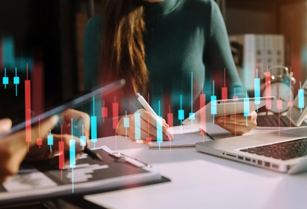 Photo two professional traides on technical price graph and indicator red and green candlestick chart and stock trading computer at office