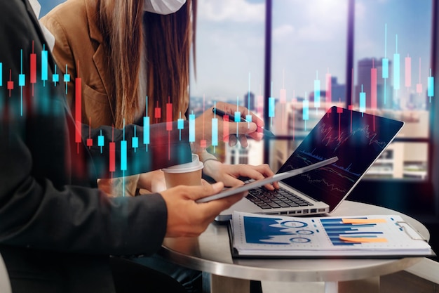 Photo two professional traides on technical price graph and indicator red and green candlestick chart and stock trading computer at office