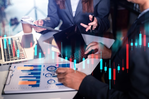 Photo two professional traides on technical price graph and indicator, red and green candlestick chart and stock trading computer at office