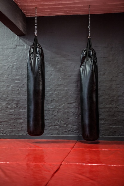 Photo two punching bags in red bowing area