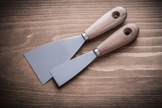 Two putty knifes with wooden handles