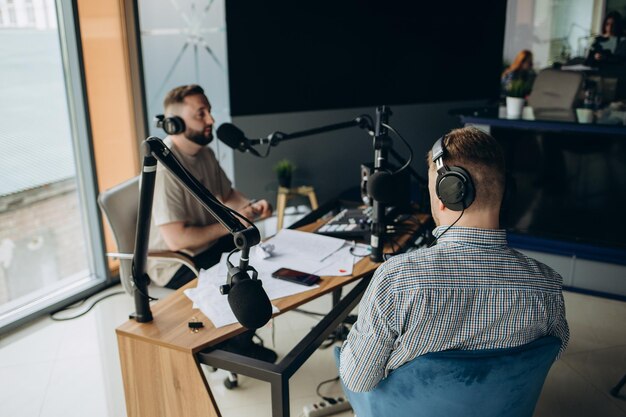 Two radio hosts moderating a live show for radio