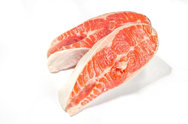 Two raw big salmon trout steaks slice of fresh raw fish ready for cooking isolated on white background