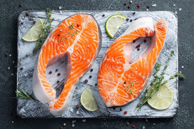 Two raw fresh salmon or trout steaks.