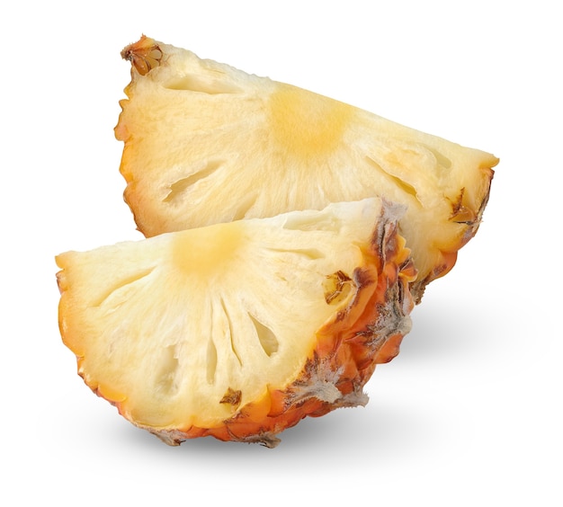 Two raw pineapple slices with a skin isolated on white