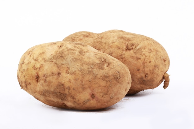 Two raw potatoes on a white mat