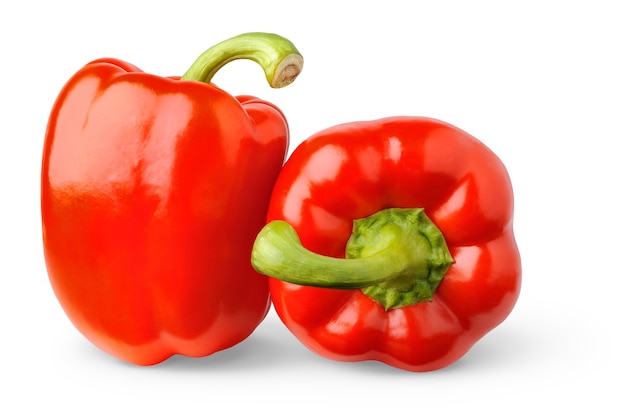 Two raw red bell peppers isolated on white surface