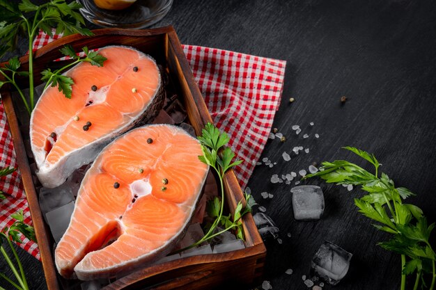 Two raw salmon steaks on ice