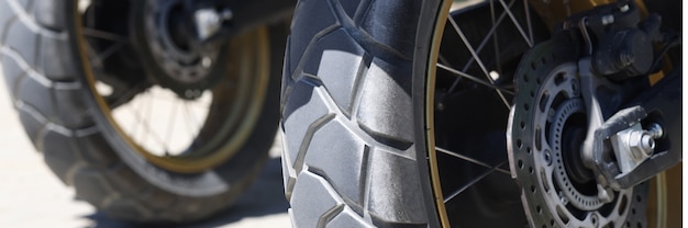 Two rear wheels of a motorcycle with brake discs closeup