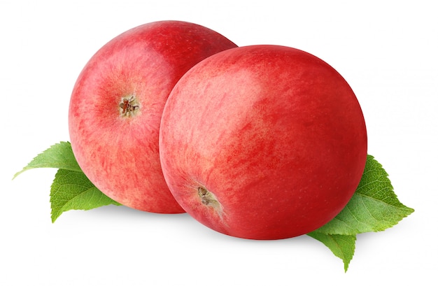 Two red apples over leaves isolated