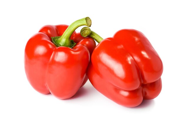 Two red bell peppers isolated on a white background