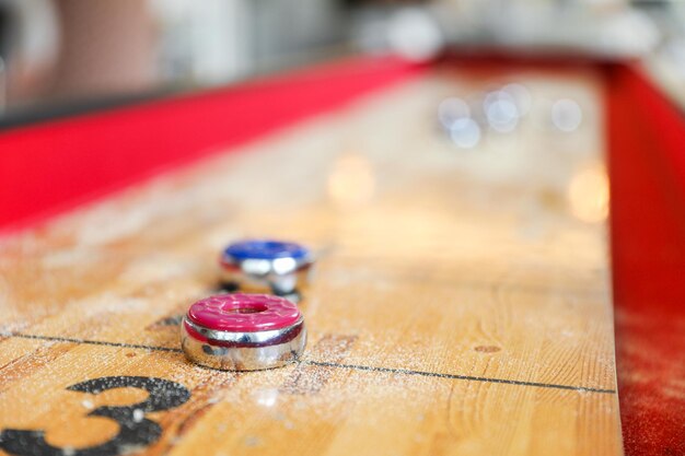 Two red and blue balls on a table with the word pool on it.