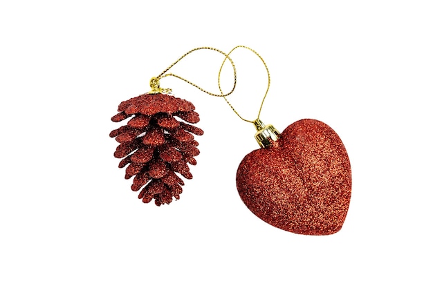 Two red Christmas tree toys heart and pine cone, isolated