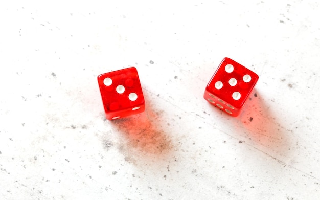 Two red craps dices showing Easy Eight number 3 and 5 overhead shot on white board.