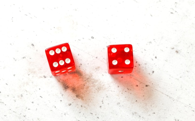 Photo two red craps dices showing easy ten (number 6 and 4) overhead shot on white board