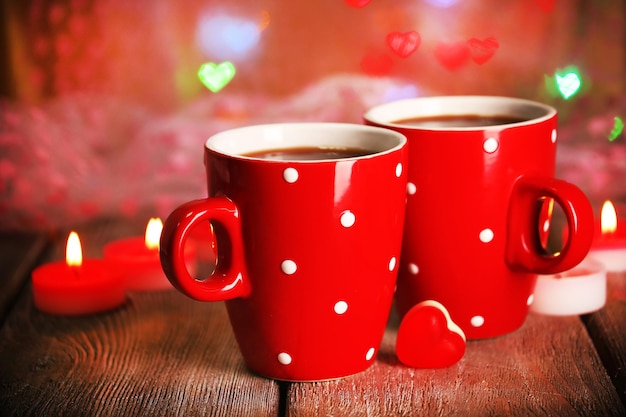 Two red cups on table on lights background