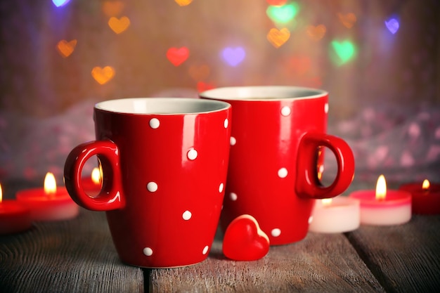 Two red cups on table on lights background