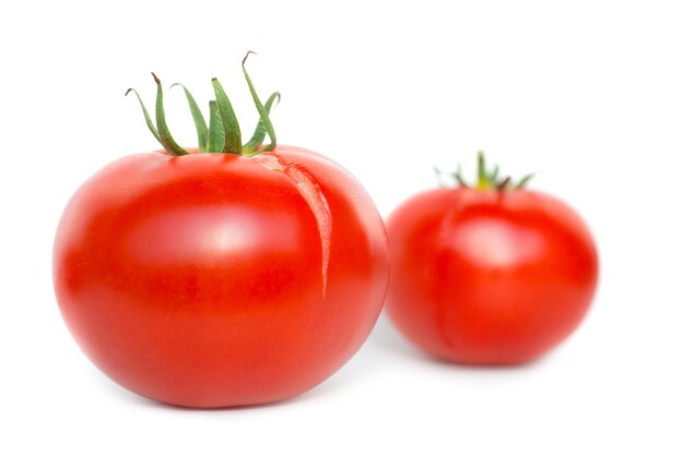 Two red fresh tomatoes isolated on white background