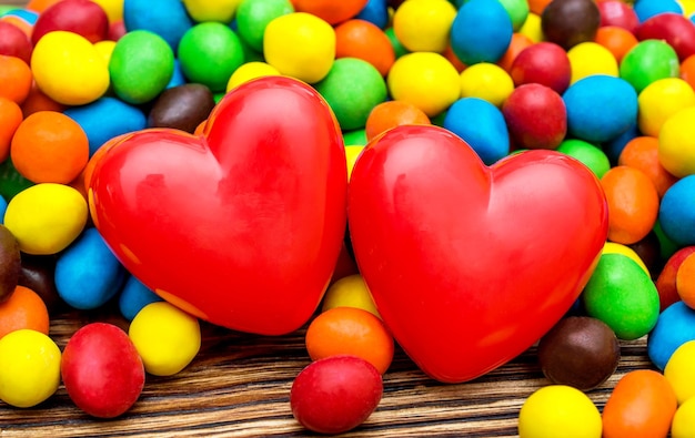 Two red heart with colorful round candies