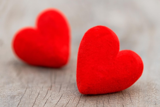 Two red hearts on brown wood table. Valentine day background