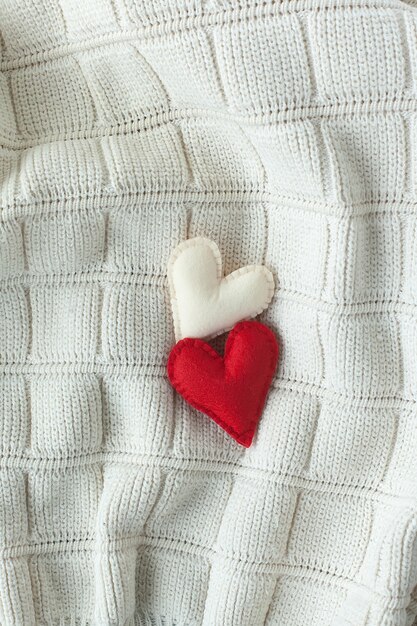 Two red hearts on a white.