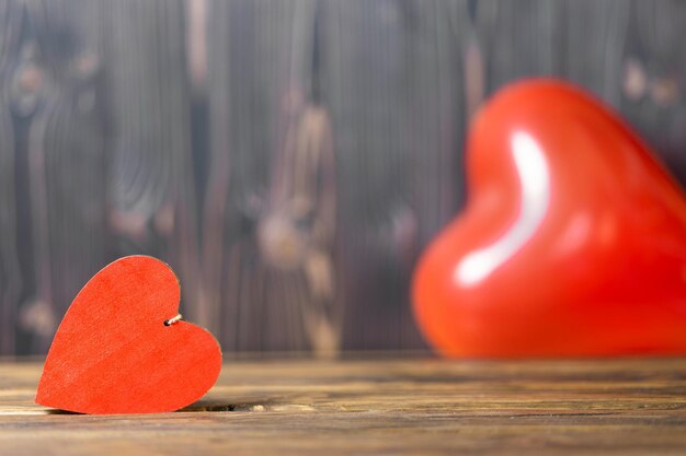 Two red hearts on a wooden background selective focus