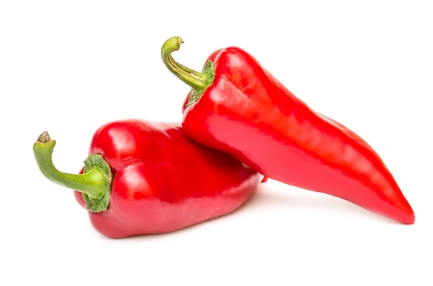 Two red sweet peppers on white