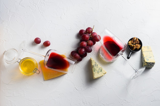 Two red wine glass with assorted cheeses