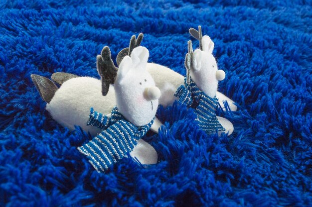 Two reindeer over blue plush