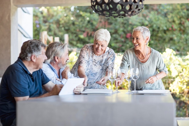 Two relaxed senior couples on terrace