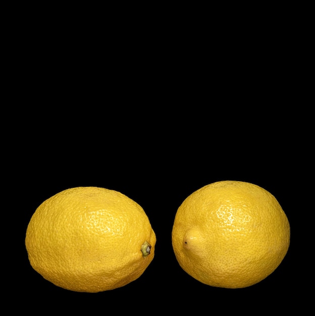 Two ripe lemons on black background