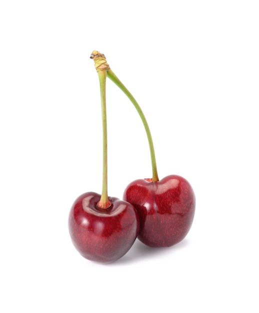 Two ripe red cherries held together by a green shank on a white background