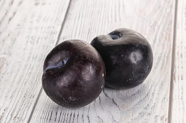 Two ripe sweet black plums