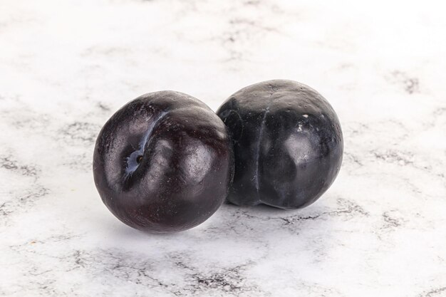 Two ripe sweet black plums