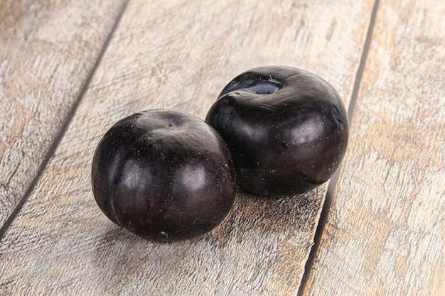 Two ripe sweet black plums