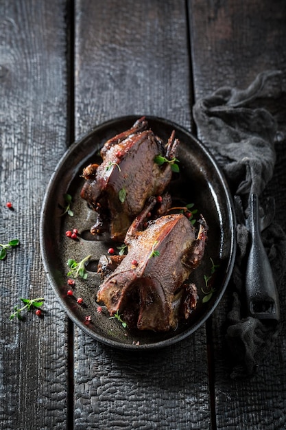 Two roasted pigeons with pepper and spices